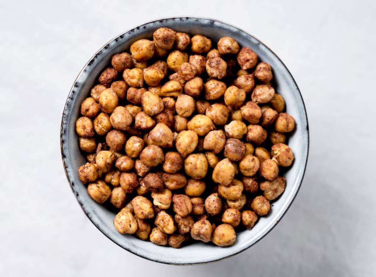 A close-up view of a bowl filled with roasted and seasoned chickpeas, showcasing their golden-brown color and crunchy texture.