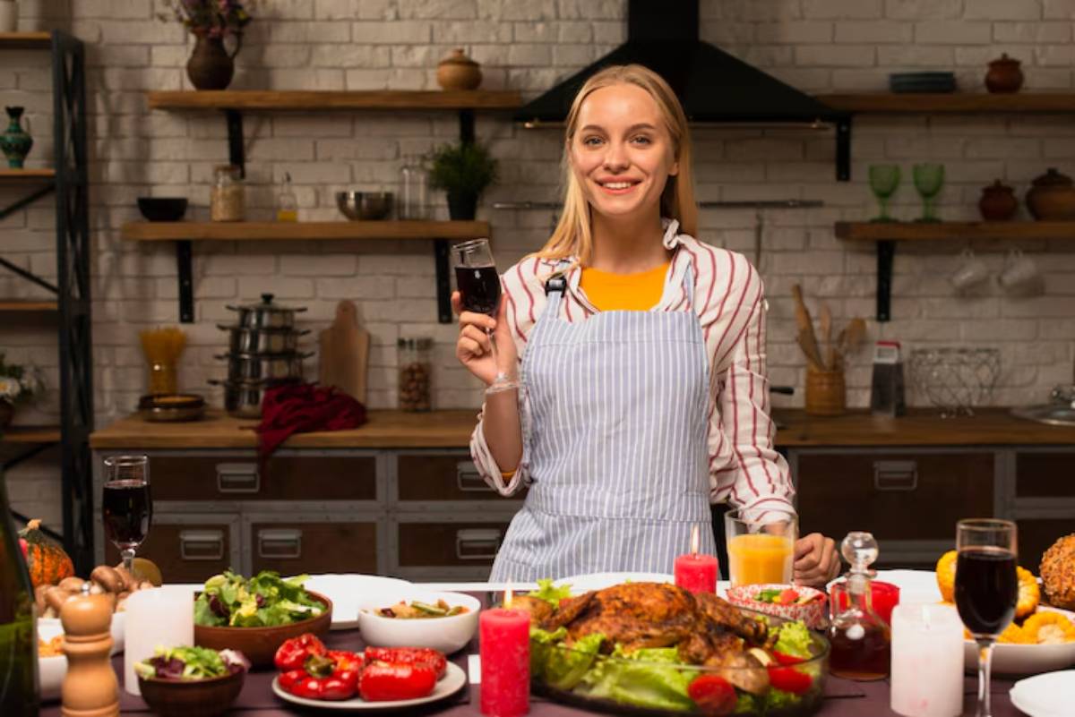 A festive table is set with various dishes, including a roasted turkey, salads, and colorful drinks, creating a warm, inviting atmosphere.
